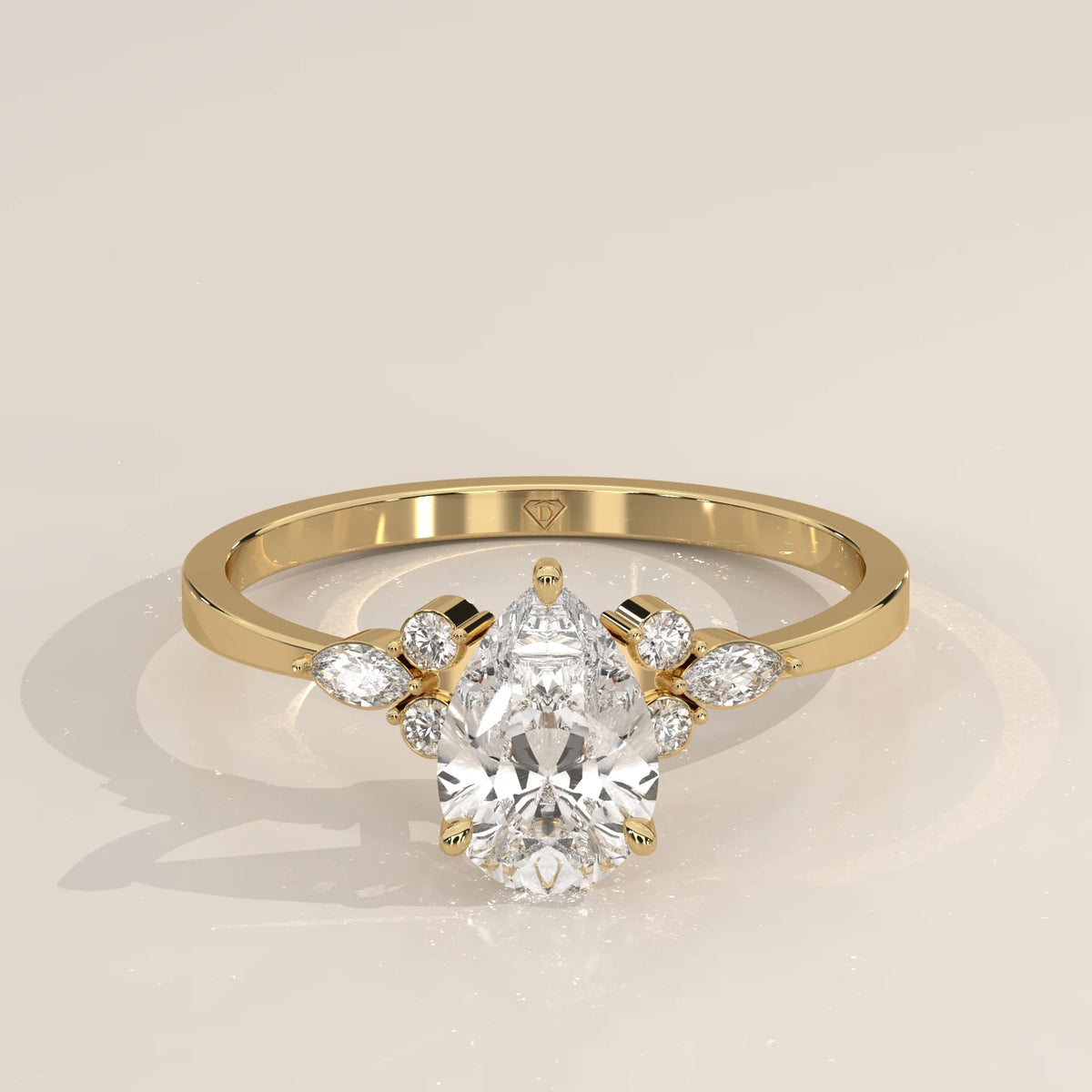 Elaborate yellow gold ring with a pear-shaped diamond center, accented with smaller stones.