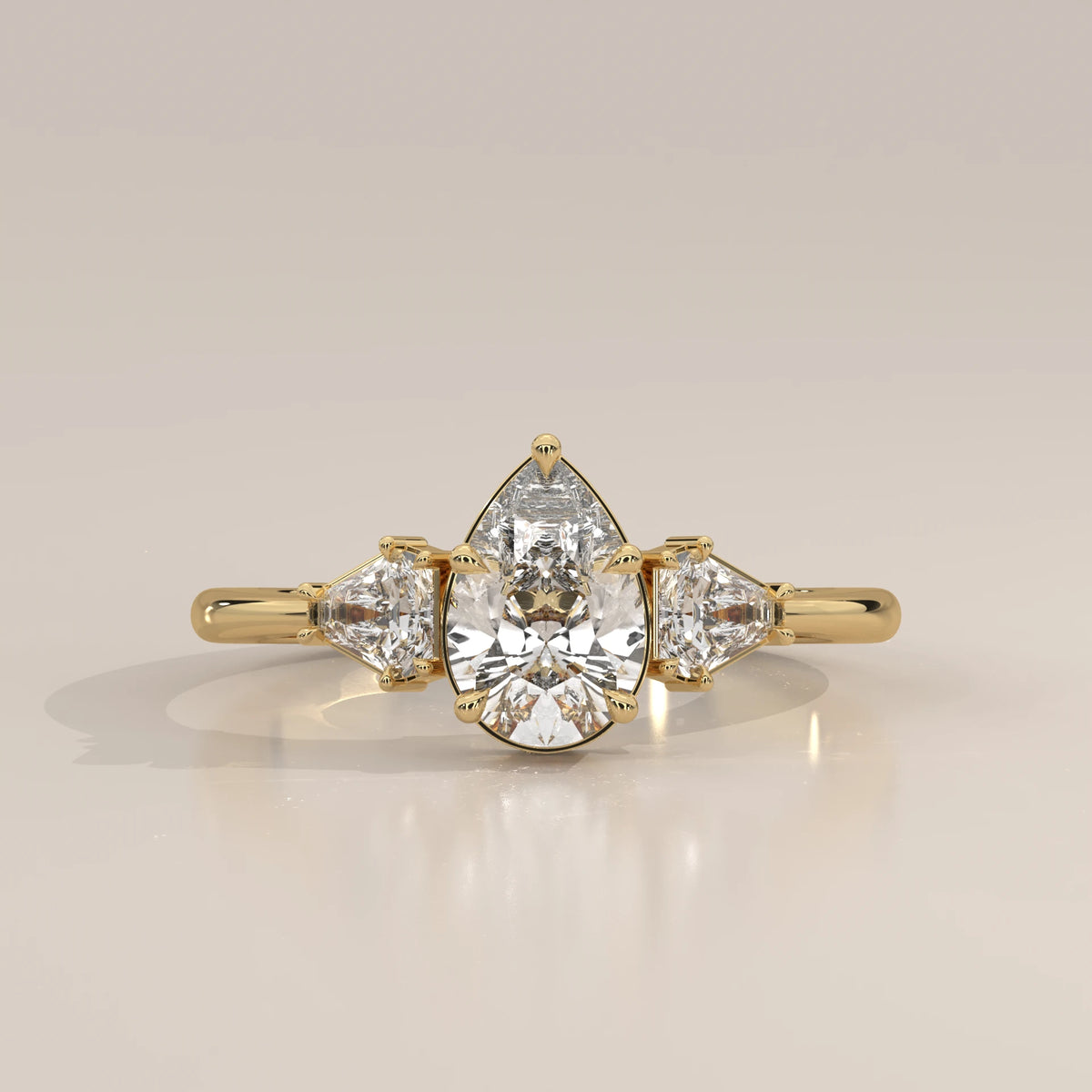 Pear Lab Grown Diamond Three Stone Ring with Shield Cut Sides in yellow gold, photographed head-on.