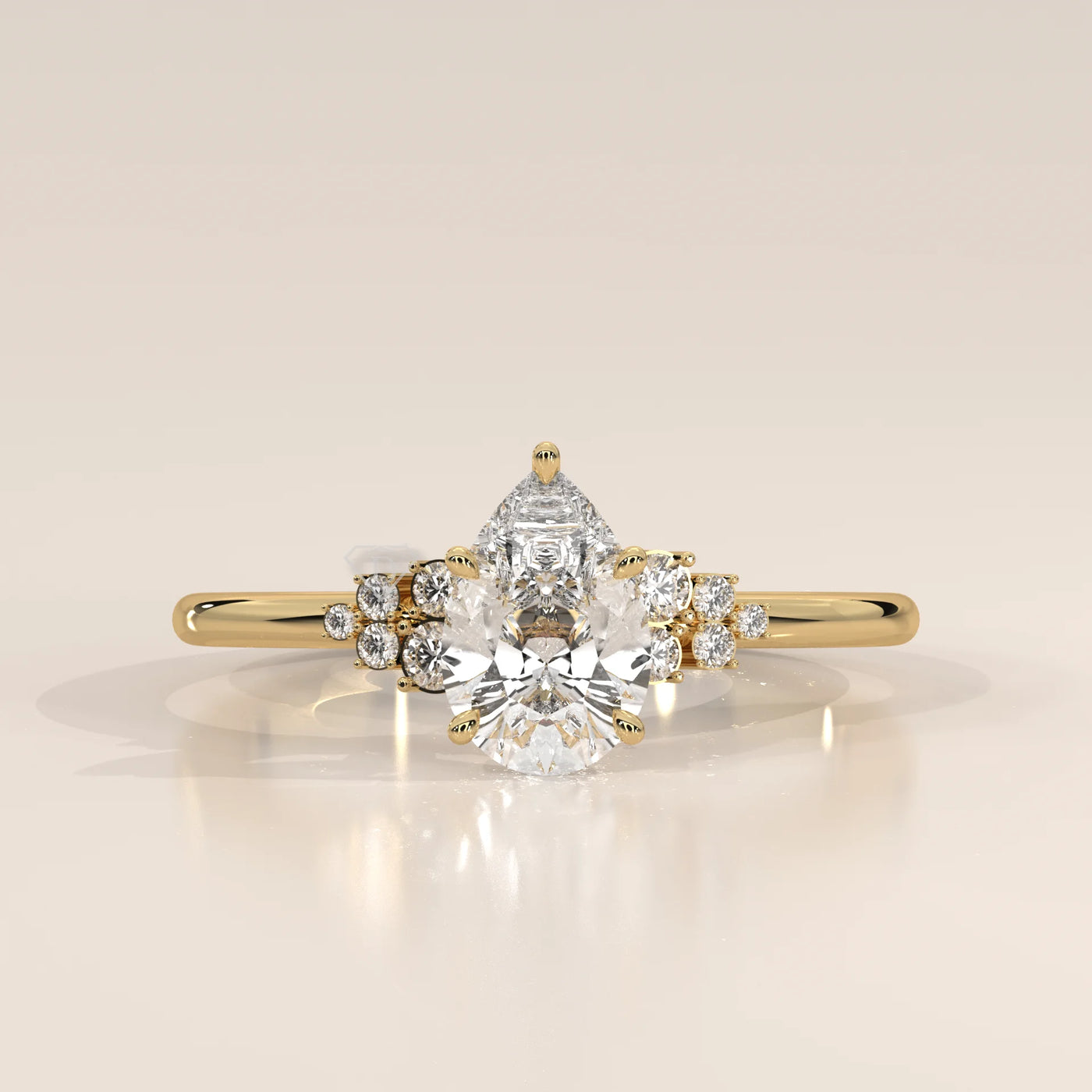Yellow gold ring with a pear-cut diamond and smaller accent stones.