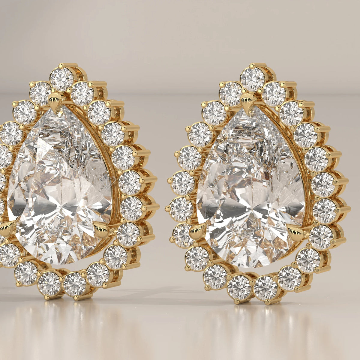 Pear Shape Halo Lab Grown Diamond Stud Earrings with Screw Backs in yellow gold, photographed head-on.