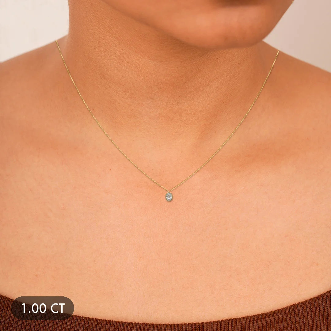 A delicate gold necklace with a small diamond pendant.