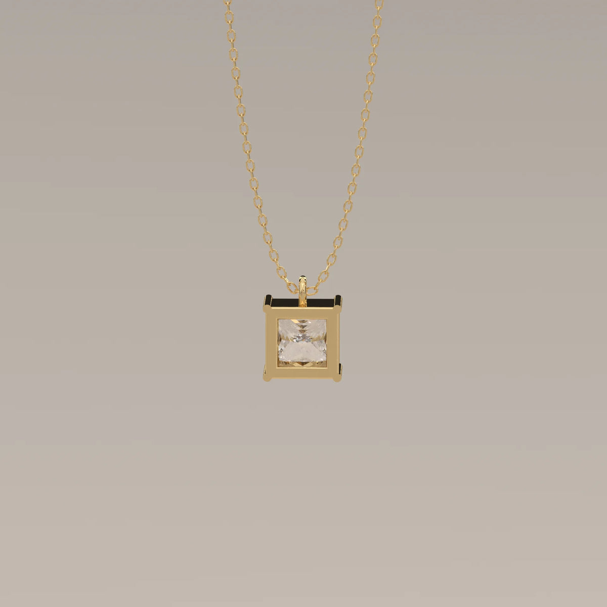 Gold necklace featuring a square pendant with a clear gemstone.