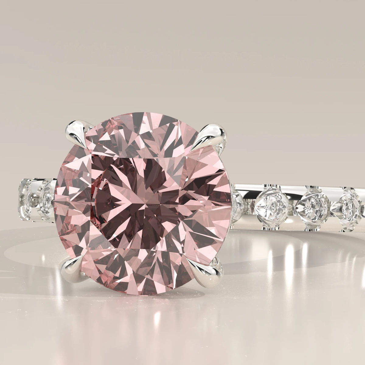 Close up of 3 carat pink round lab grown diamond and four claws