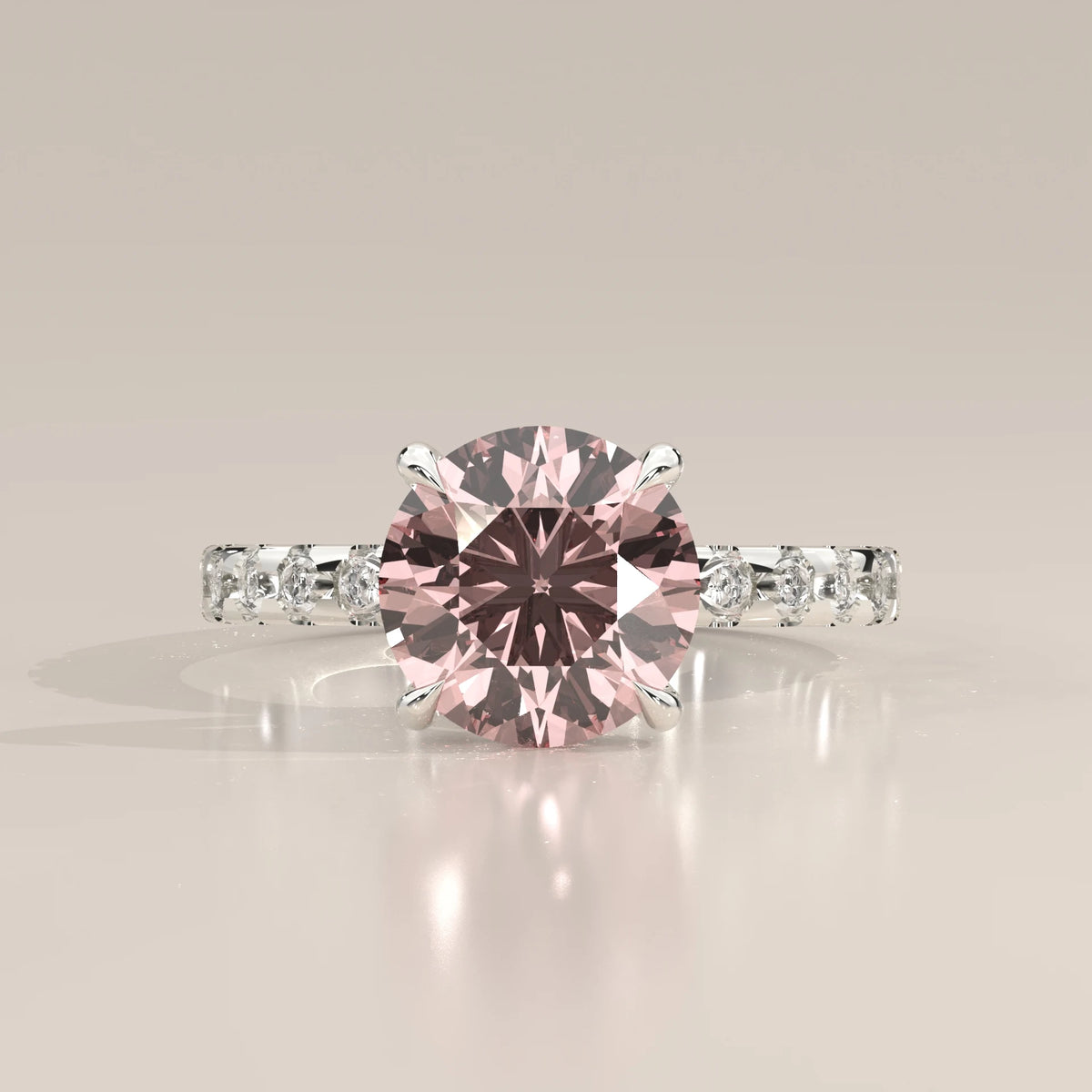 Front view of pink round lab grown diamond in four claw setting with white diamond band