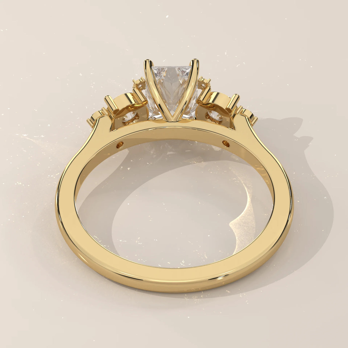 Gold ring with a princess-cut diamond and smaller accent stones.