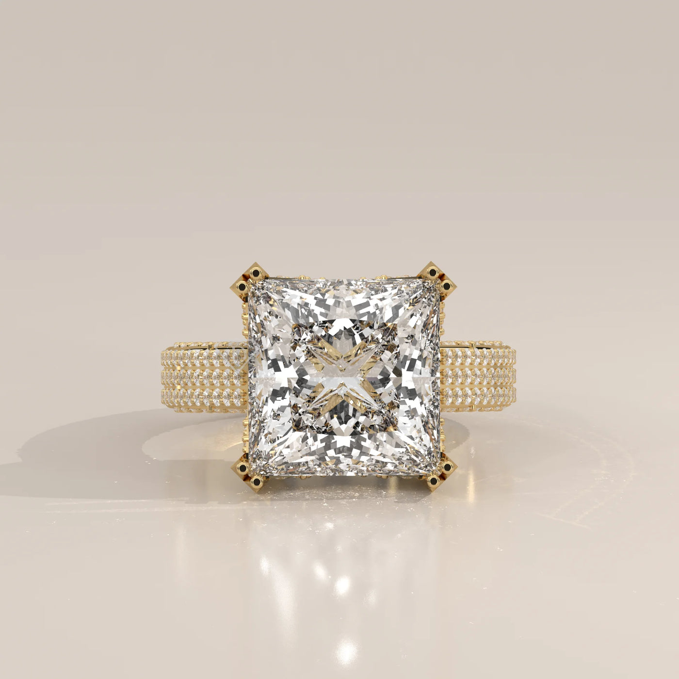A stunning 14k yellow gold engagement ring with a large princess-cut diamond and pav
e-set side stones.