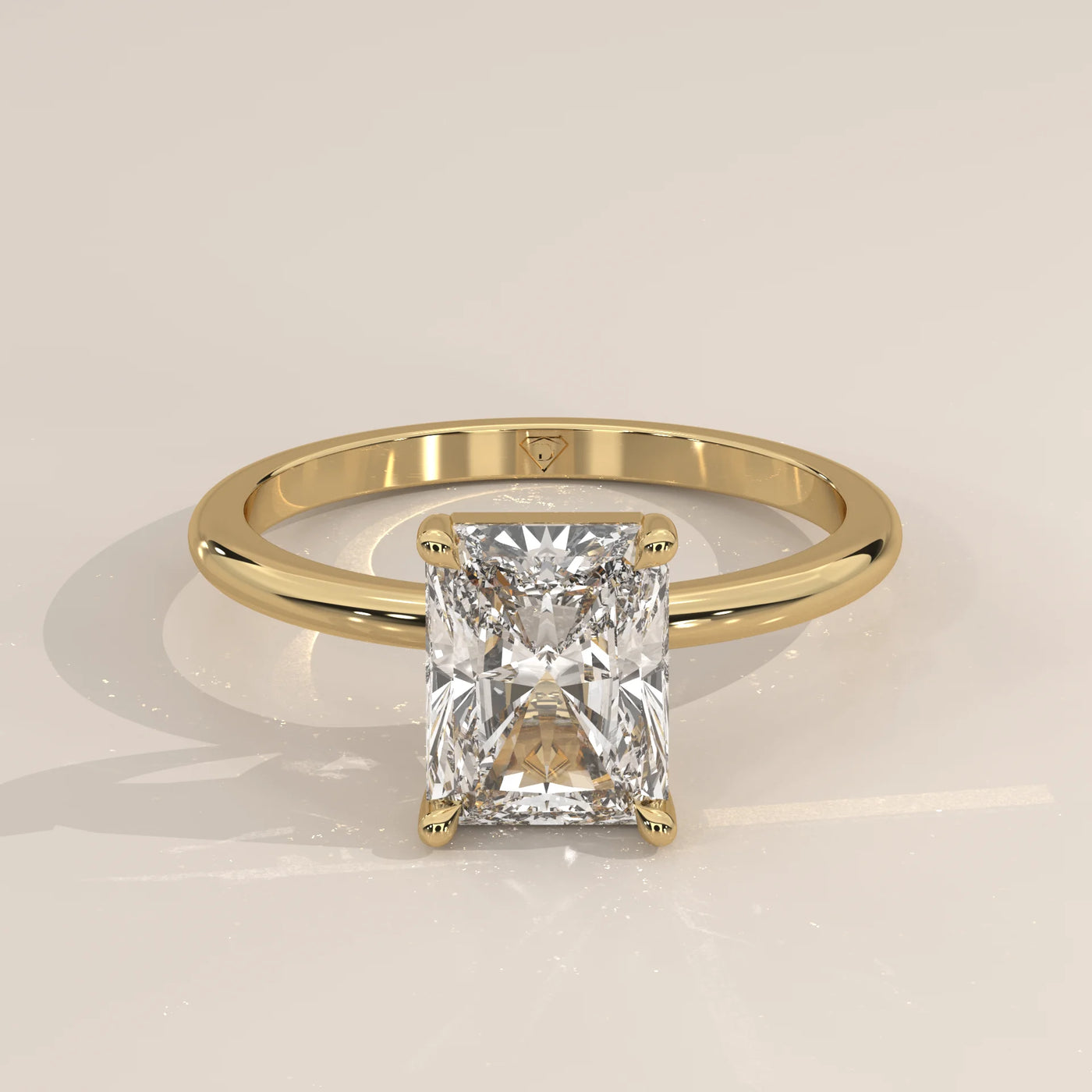 A radiant-cut diamond set in a classic yellow gold engagement ring.