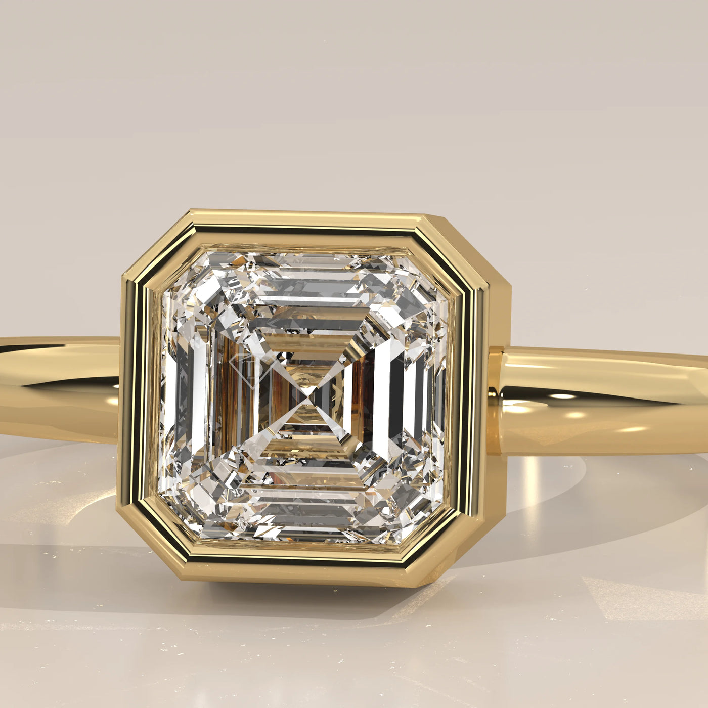 Close-up of a 14k yellow gold ring with a bezeled asscher-cut diamond.