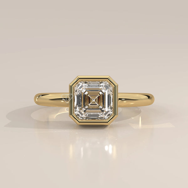 Gold ring with a square-cut diamond in a bezel setting.