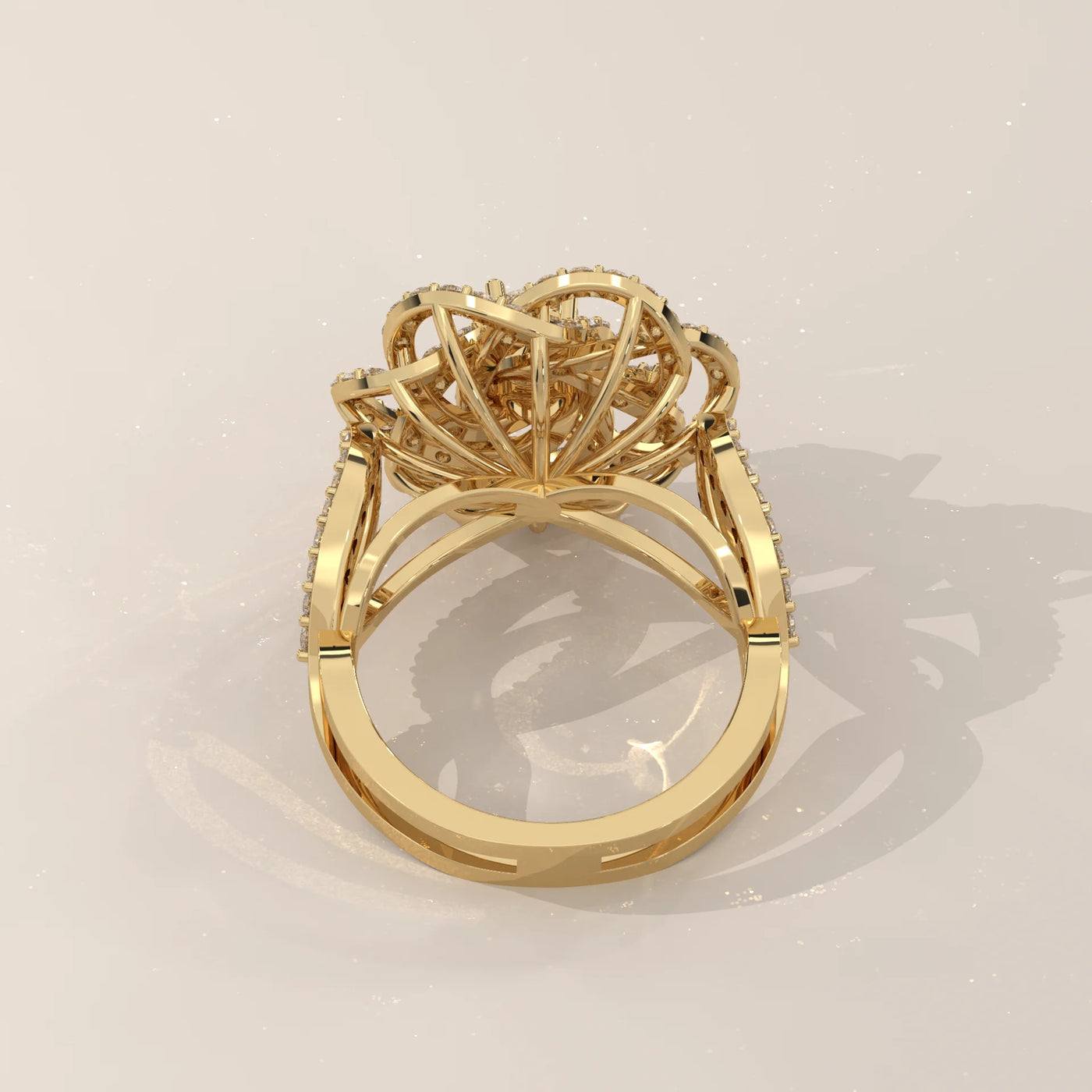 A detailed yellow gold ring with a cluster of diamonds, shown from the back.