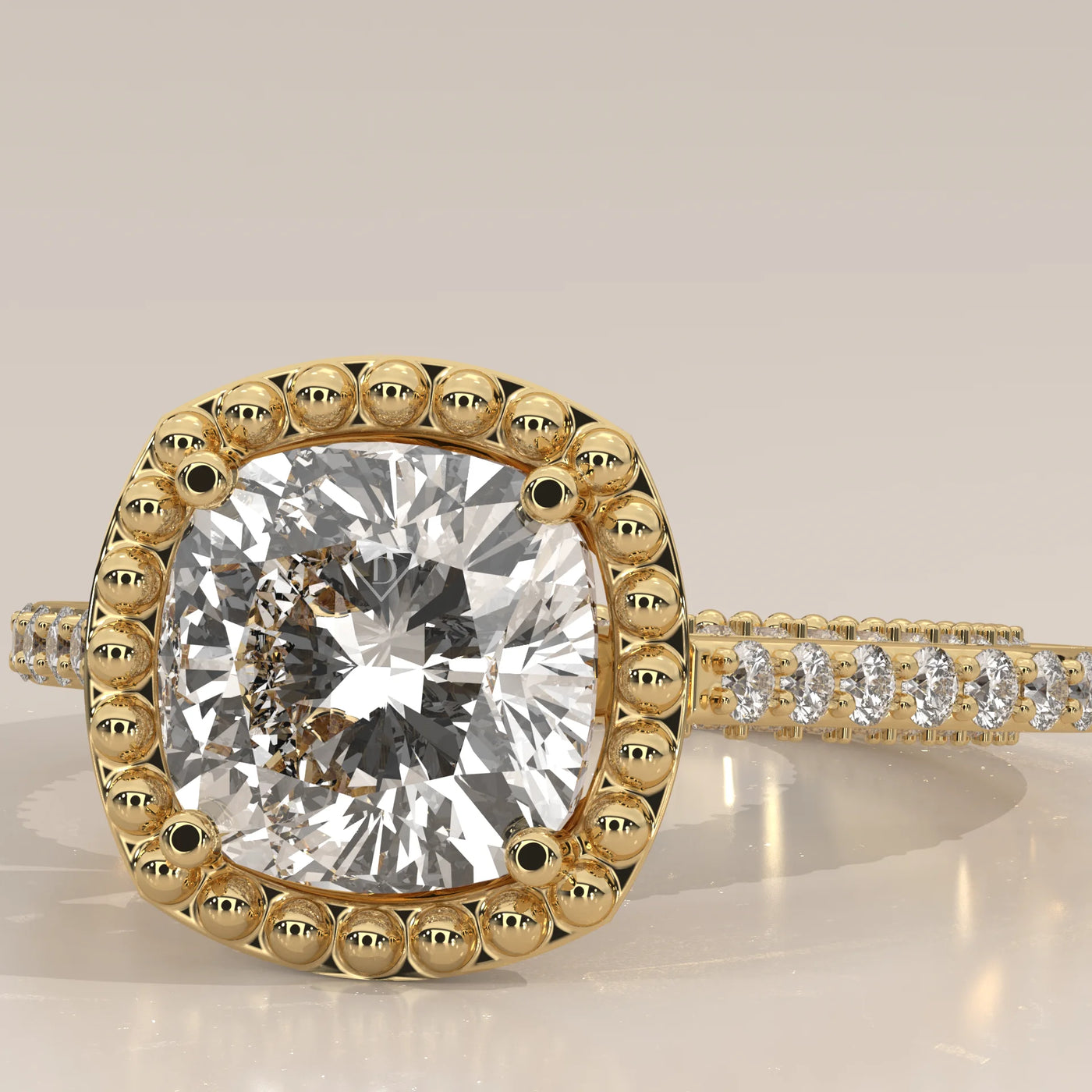 Gold ring with a cushion-cut diamond surrounded by beading.