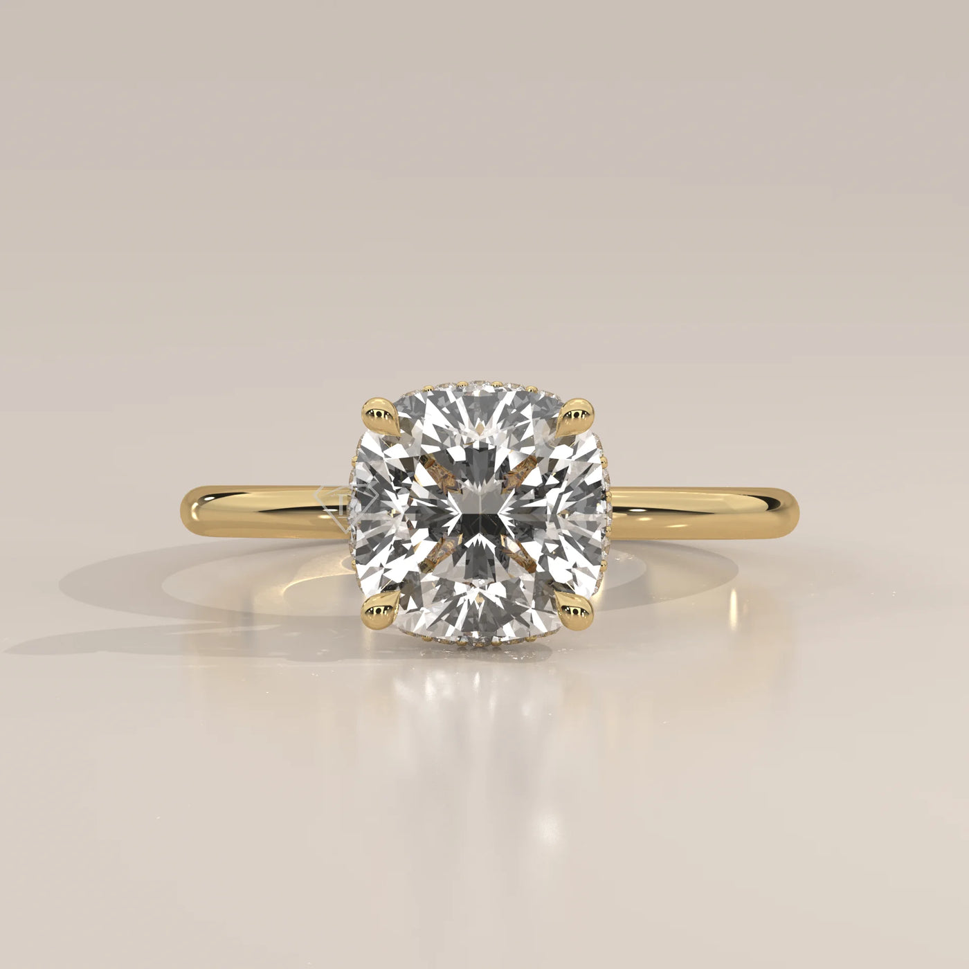 A cushion-cut diamond engagement ring in 14k yellow gold with pavé band.