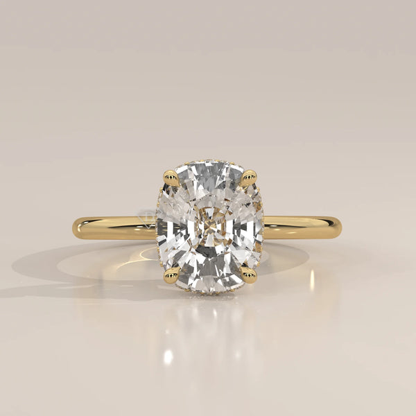 A cushion-cut diamond engagement ring in 14k yellow gold with pavé band.