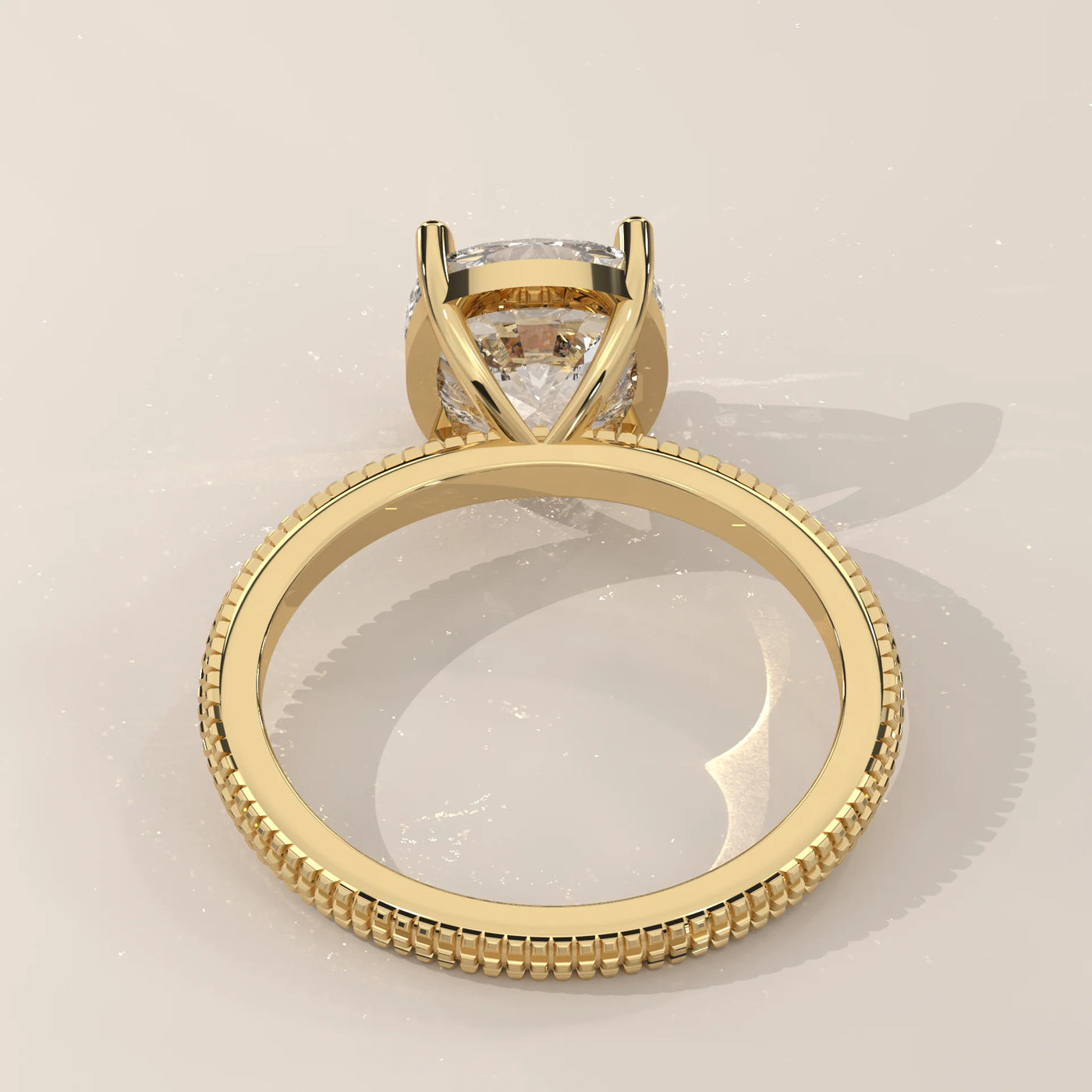 Yellow gold ring with a cushion-cut diamond and beaded band.
