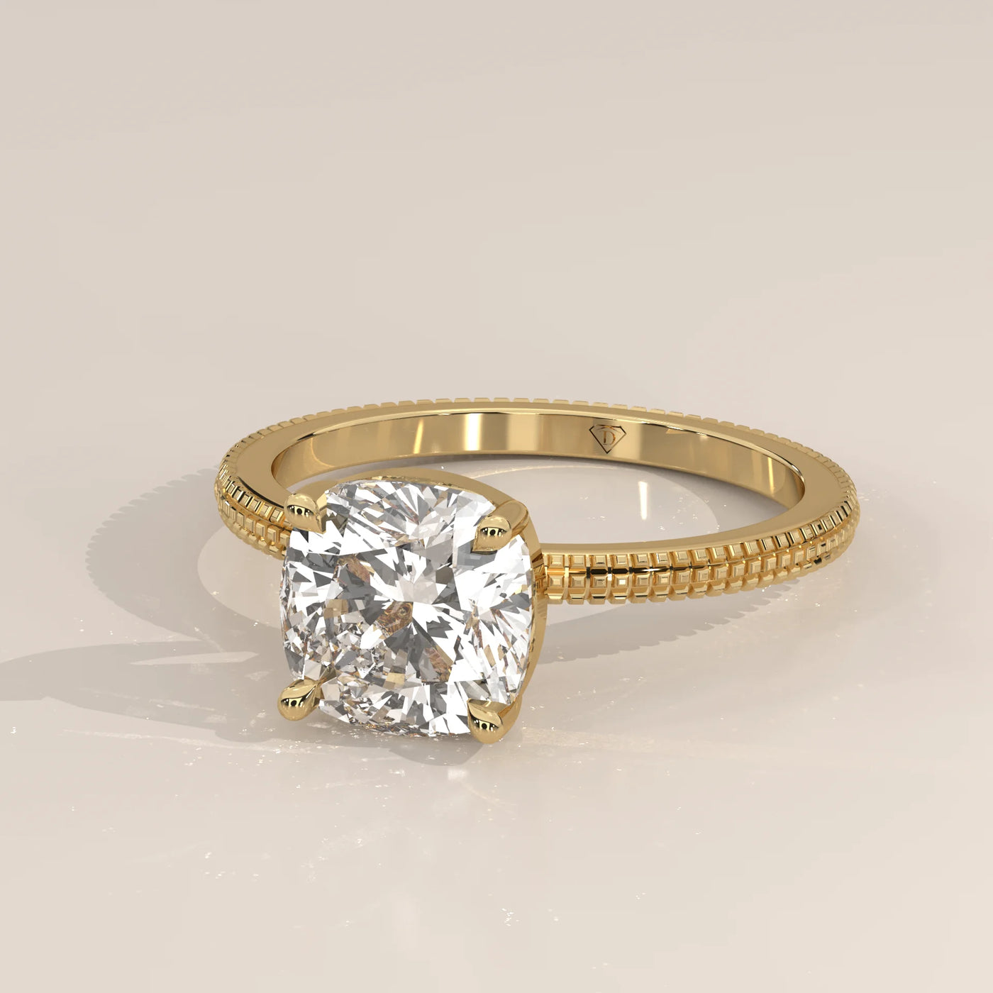 Yellow gold ring with a cushion-cut diamond in a bezel setting.