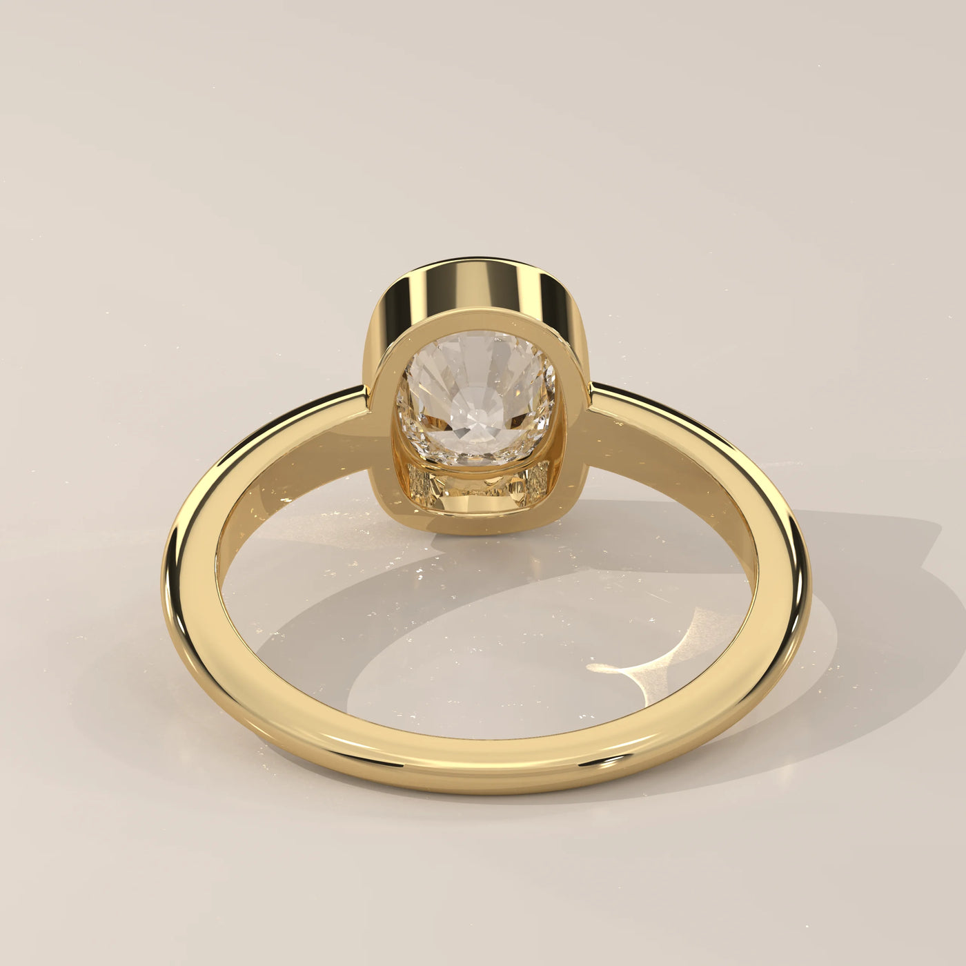 Yellow gold ring with a bezeled cushion-cut diamond, viewed from the back.