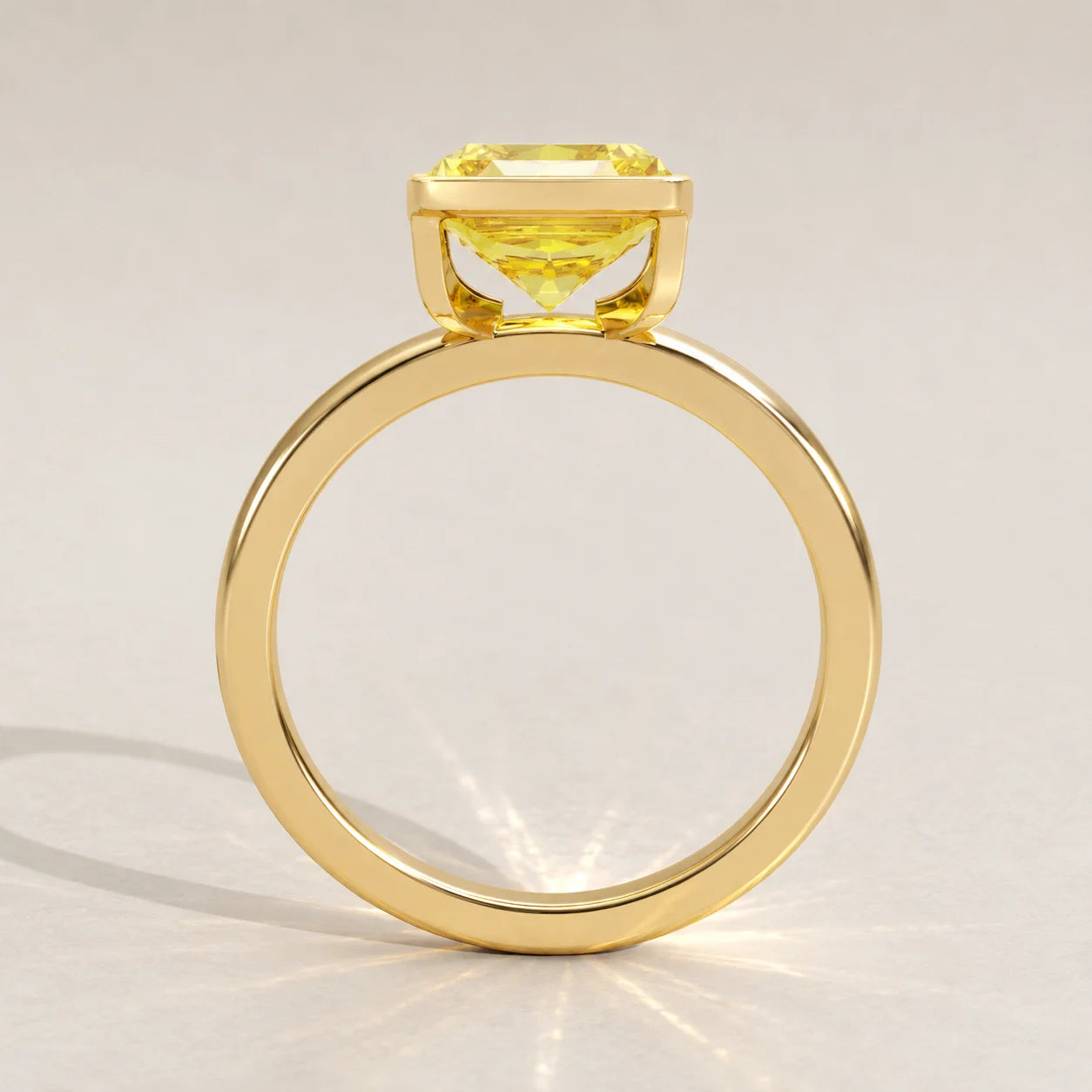 A 14k yellow gold ring with a cushion-cut yellow sapphire.