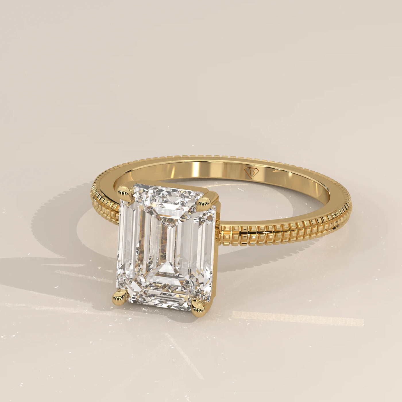 A 14k yellow gold ring with an emerald-cut diamond and pavé band.
