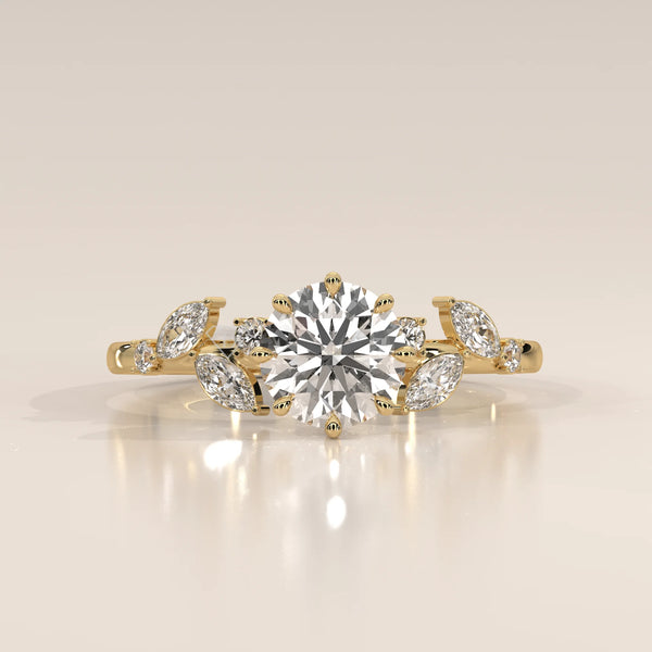 Yellow gold engagement ring with a central diamond and floral accents.