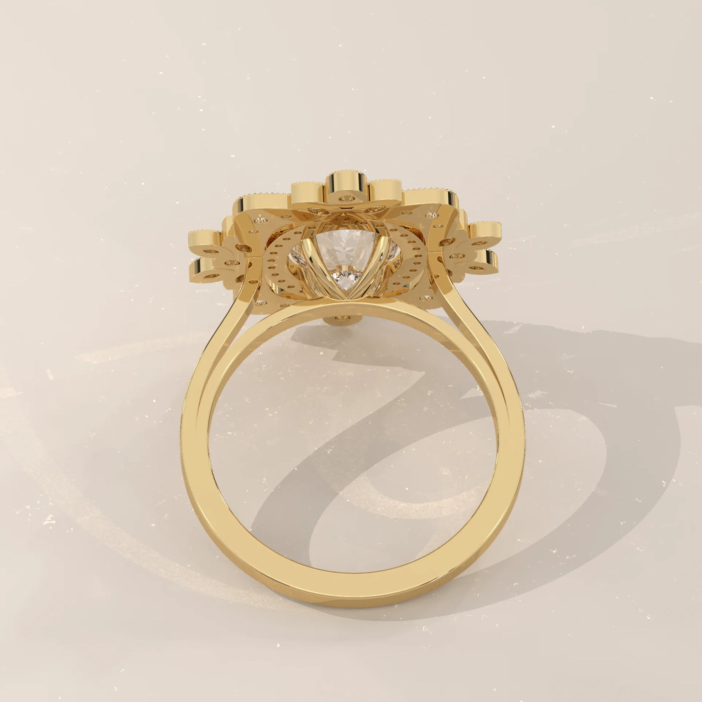 A yellow gold ring with a central diamond surrounded by a halo of smaller diamonds.