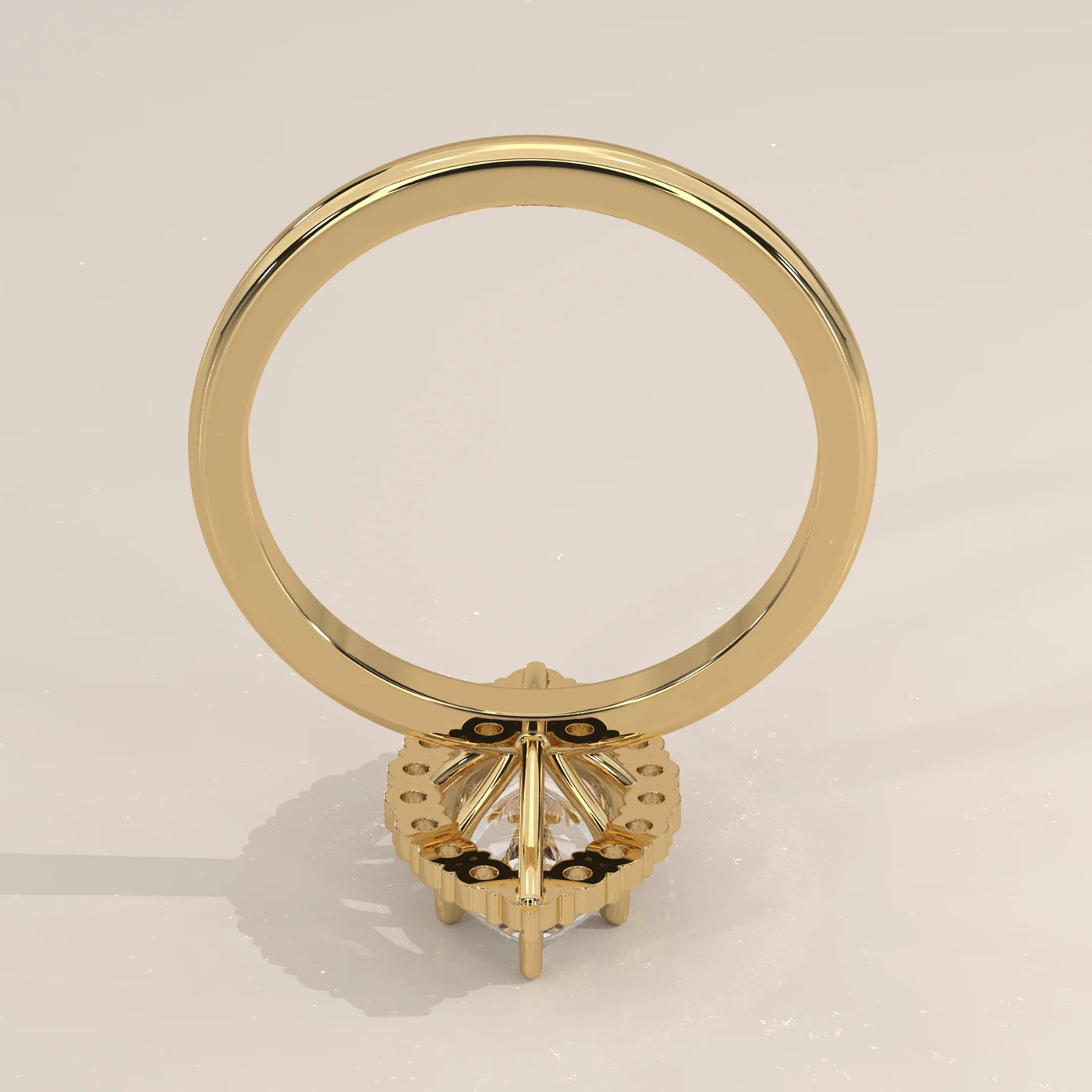 A yellow gold ring with a halo of small diamonds around a central diamond.