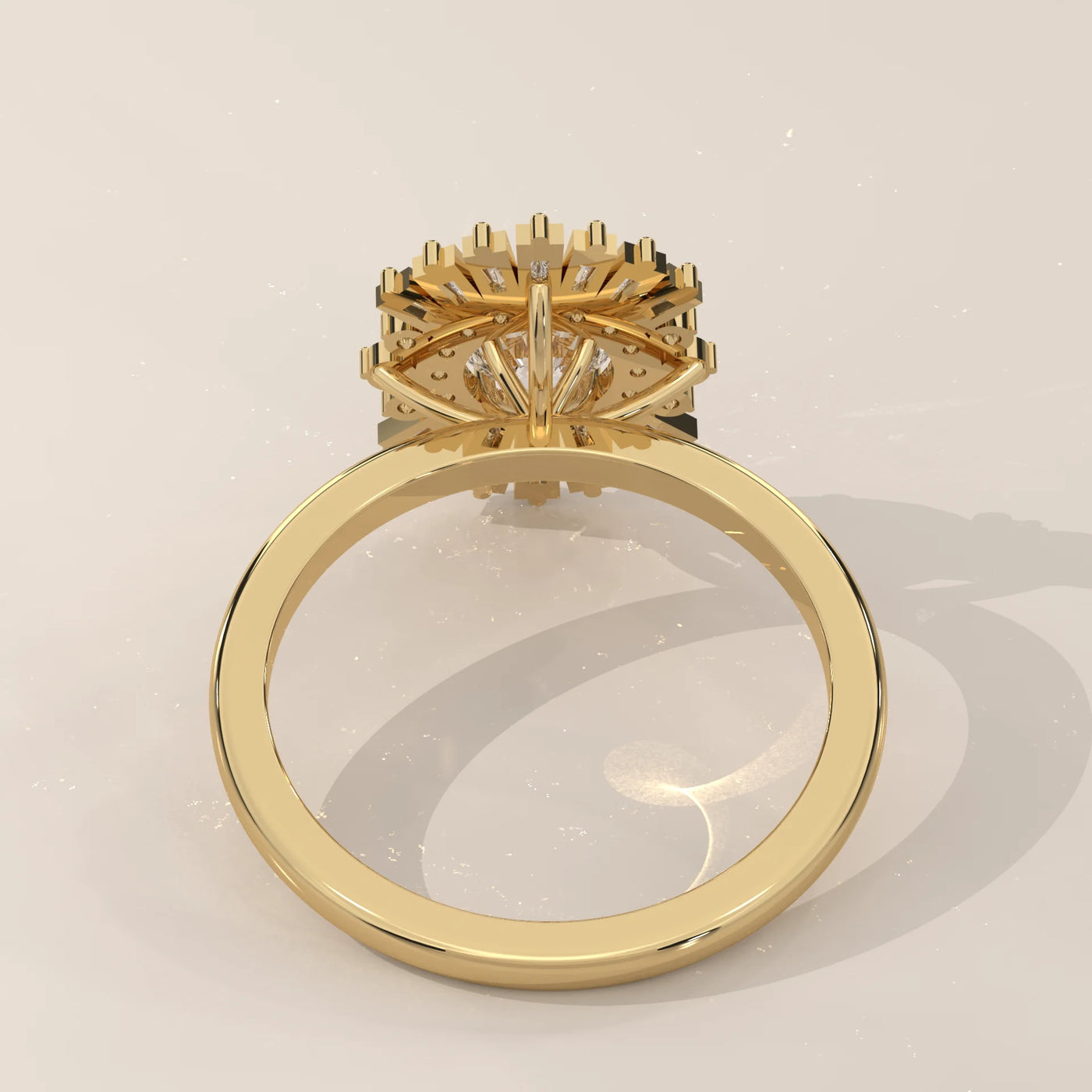 A yellow gold ring with a diamond halo setting, shown from the bottom.