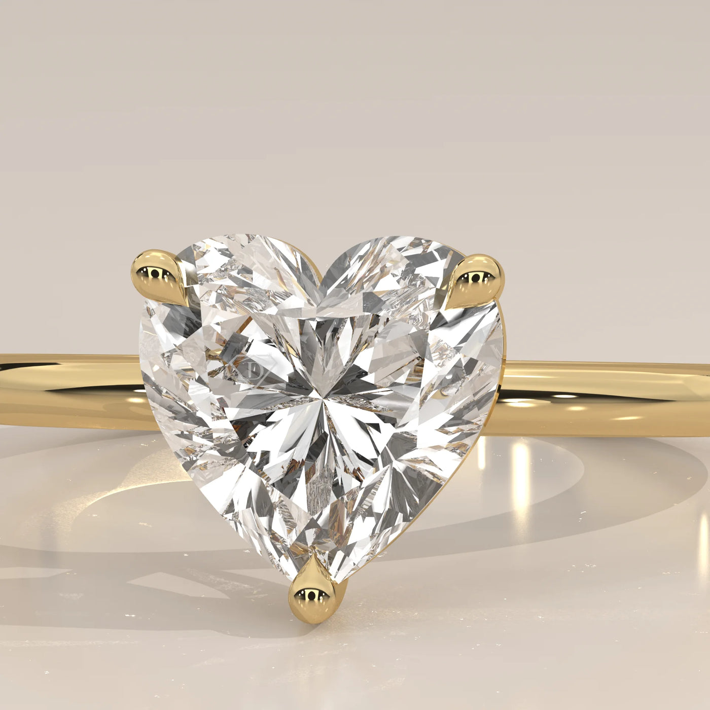 Close-up of a heart-shaped diamond ring in yellow gold.