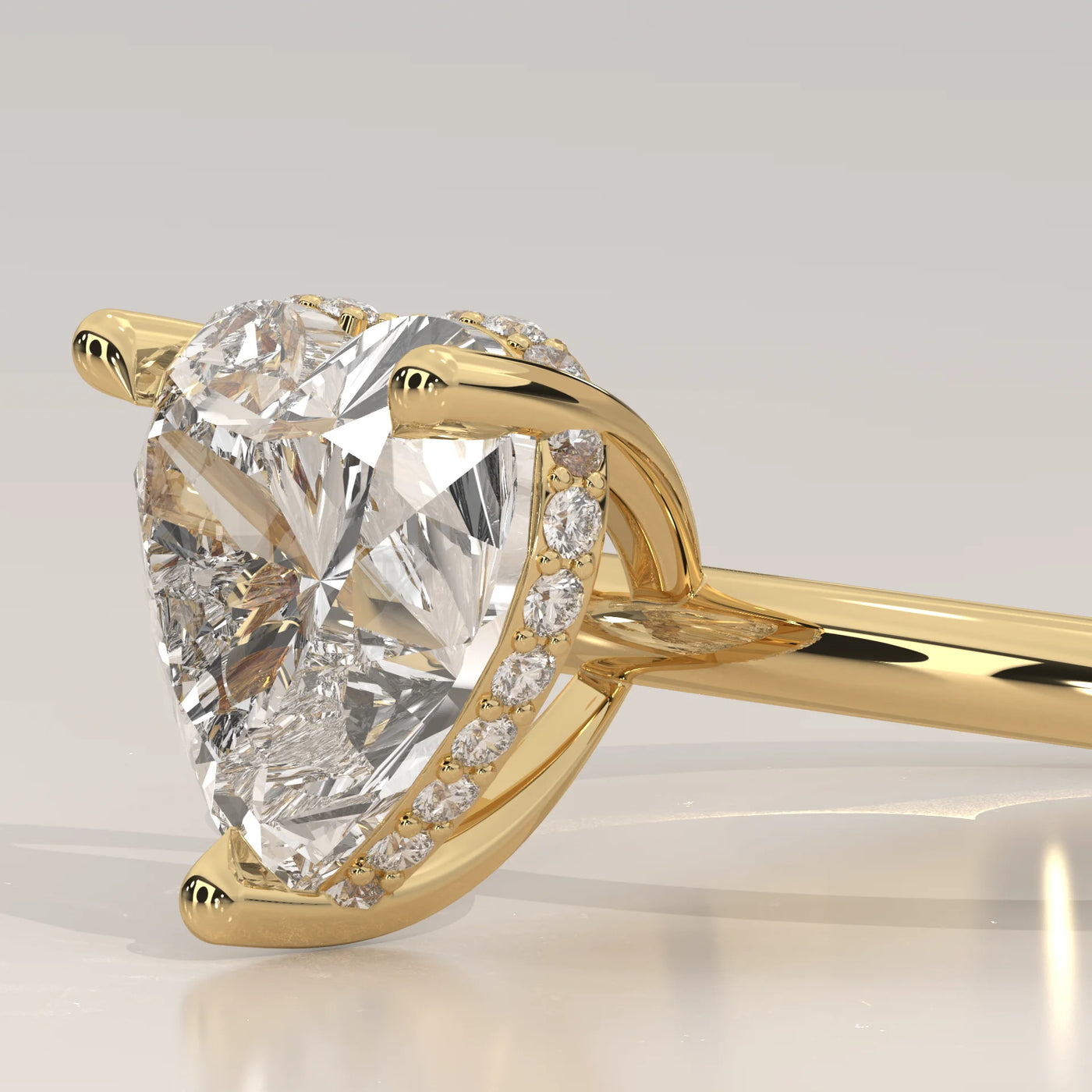 A close-up side view of a 14k yellow gold ring with a heart-shaped diamond.