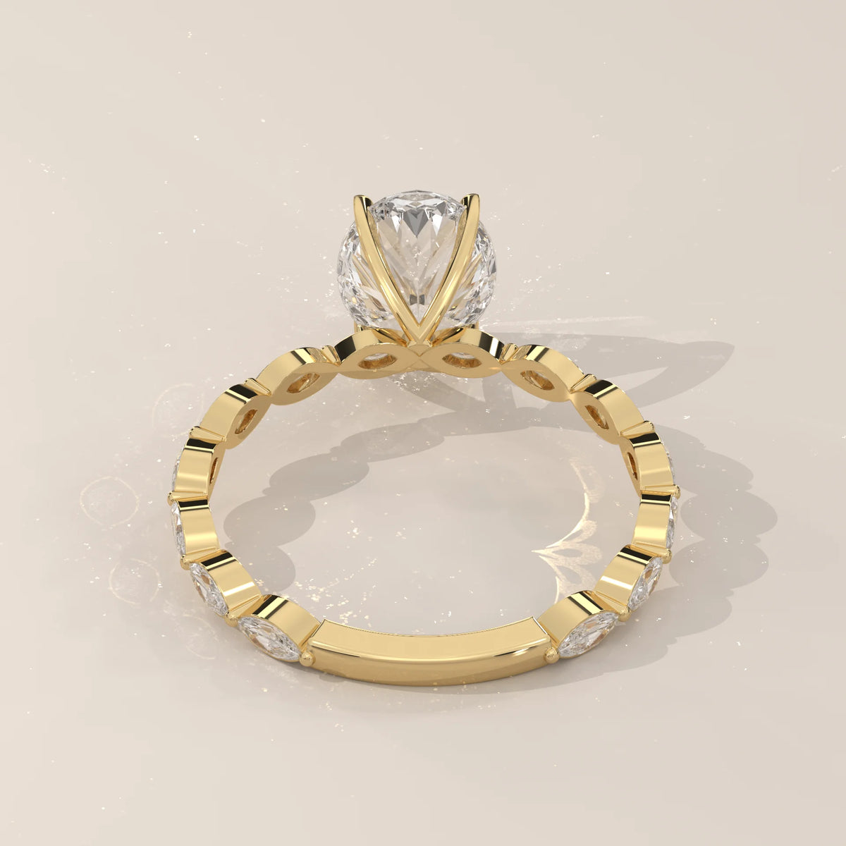 Gold ring with a central diamond and a band of marquise-cut diamonds.