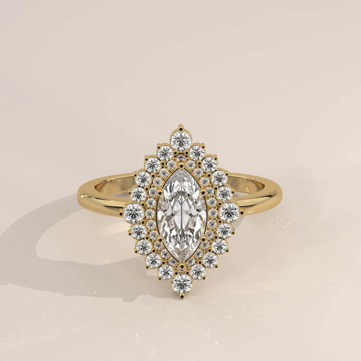 A yellow gold ring with a marquise cut diamond surrounded by a halo of small diamonds.