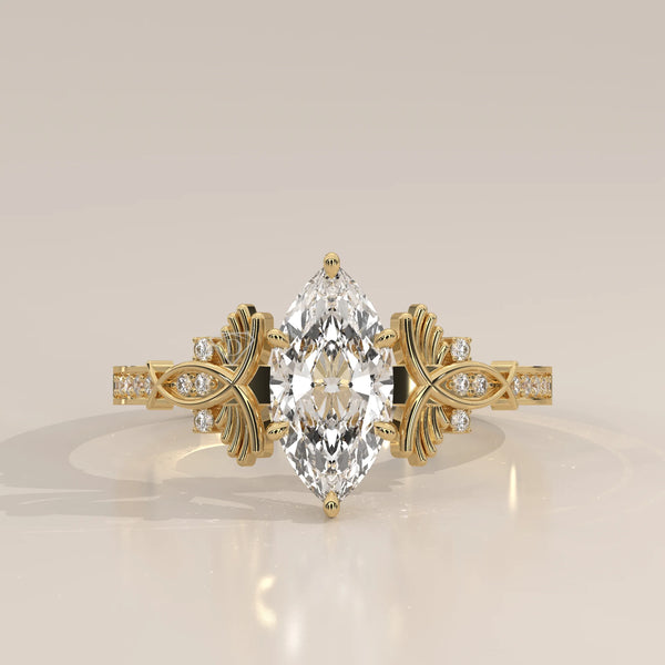Elegant yellow gold ring with marquise cut diamond and accent stones.