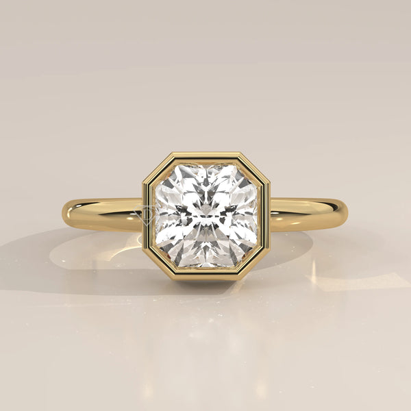 A yellow gold ring with an octagon-shaped diamond in a bezel setting.
