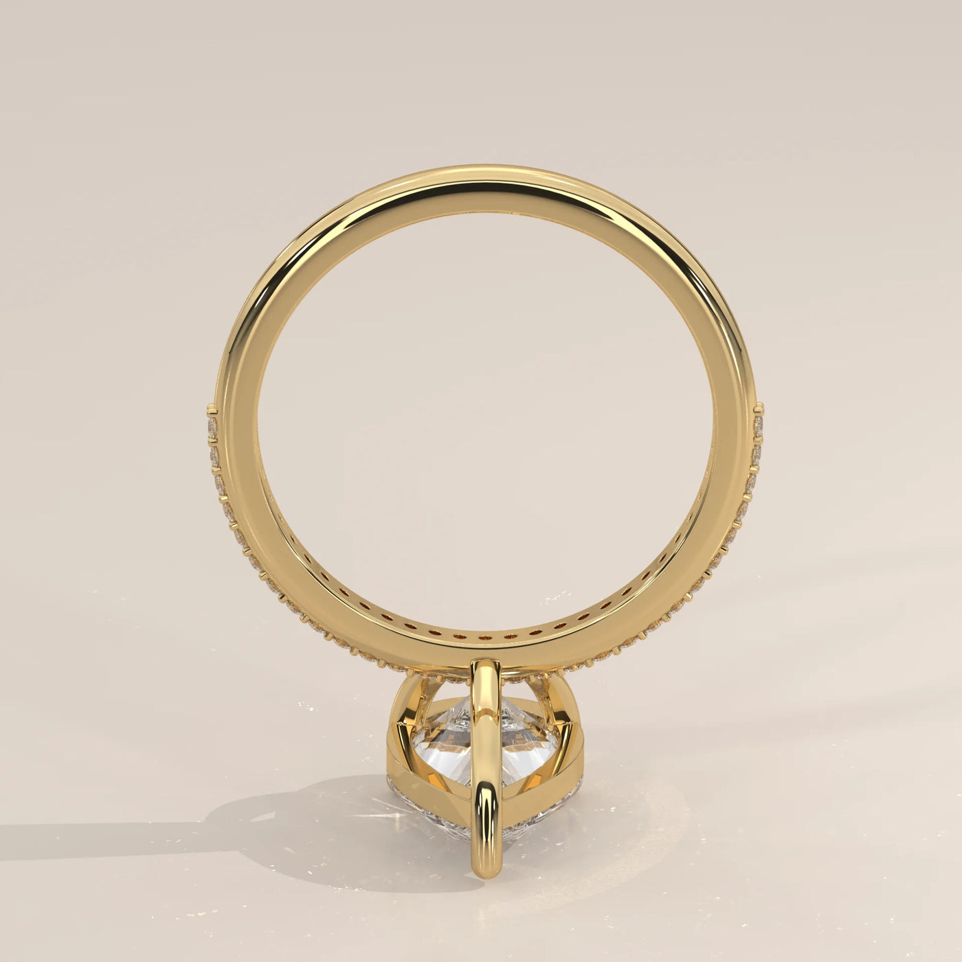 Side view of a 14k yellow gold ring with pavé diamonds and a center stone.