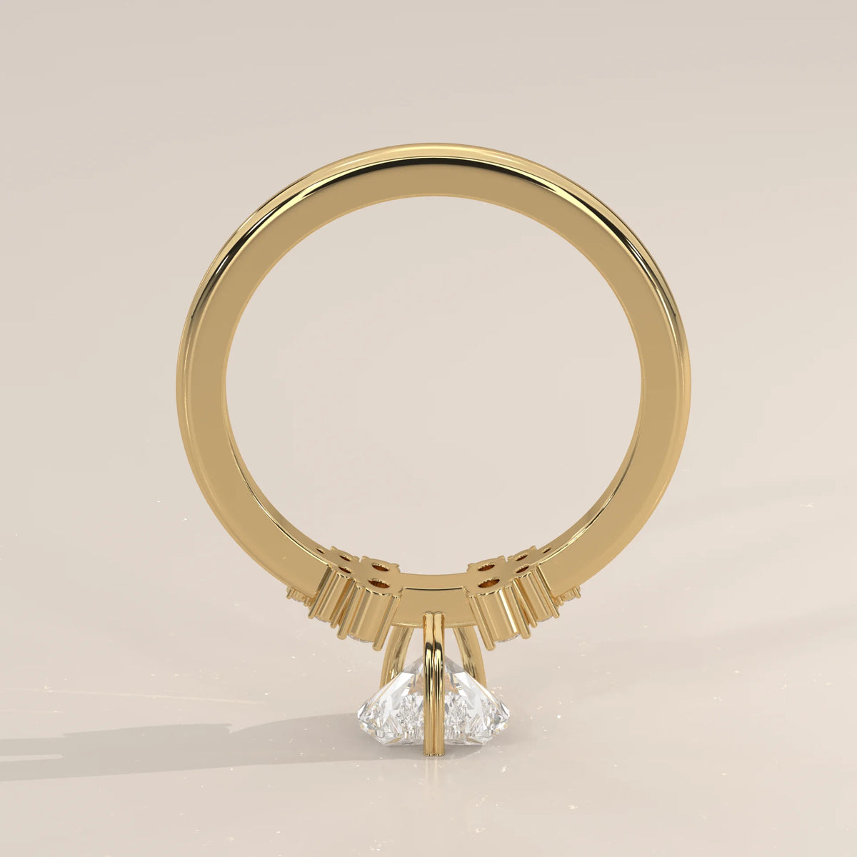 A pear-cut diamond engagement ring in yellow gold.