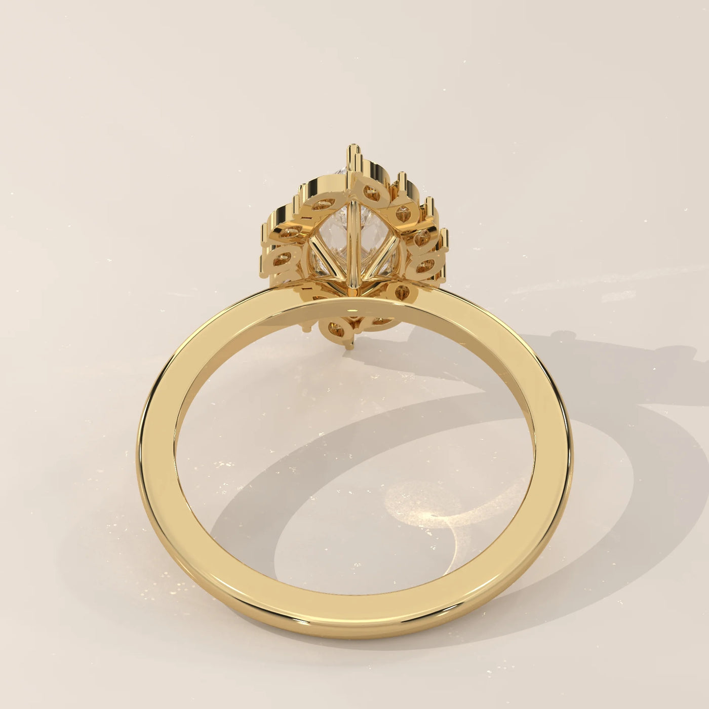 Yellow gold ring with a pear-shaped diamond and smaller accent diamonds.