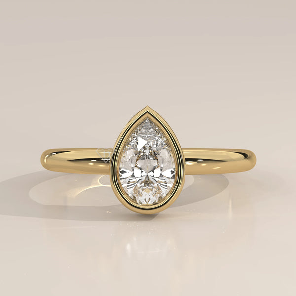 A classic 14k gold ring with a prominent pear-shaped diamond.