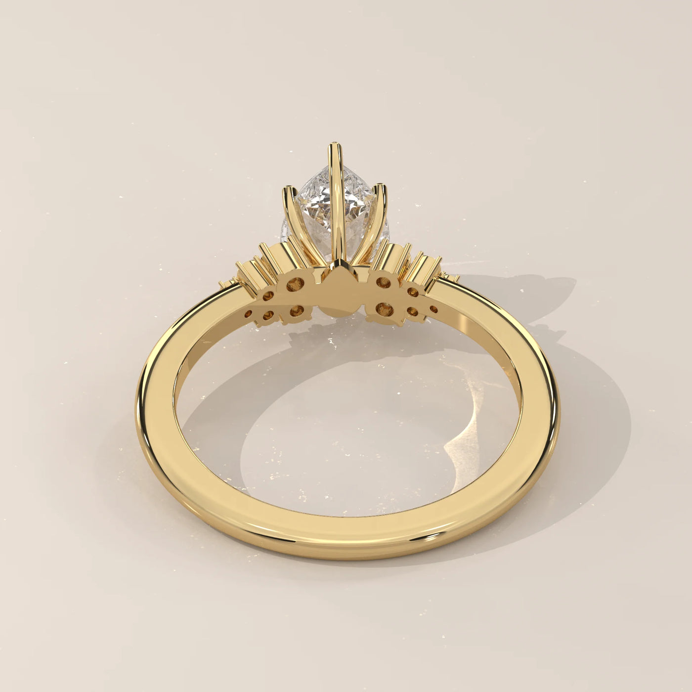 Gold ring with a pear-cut diamond and accent stones.