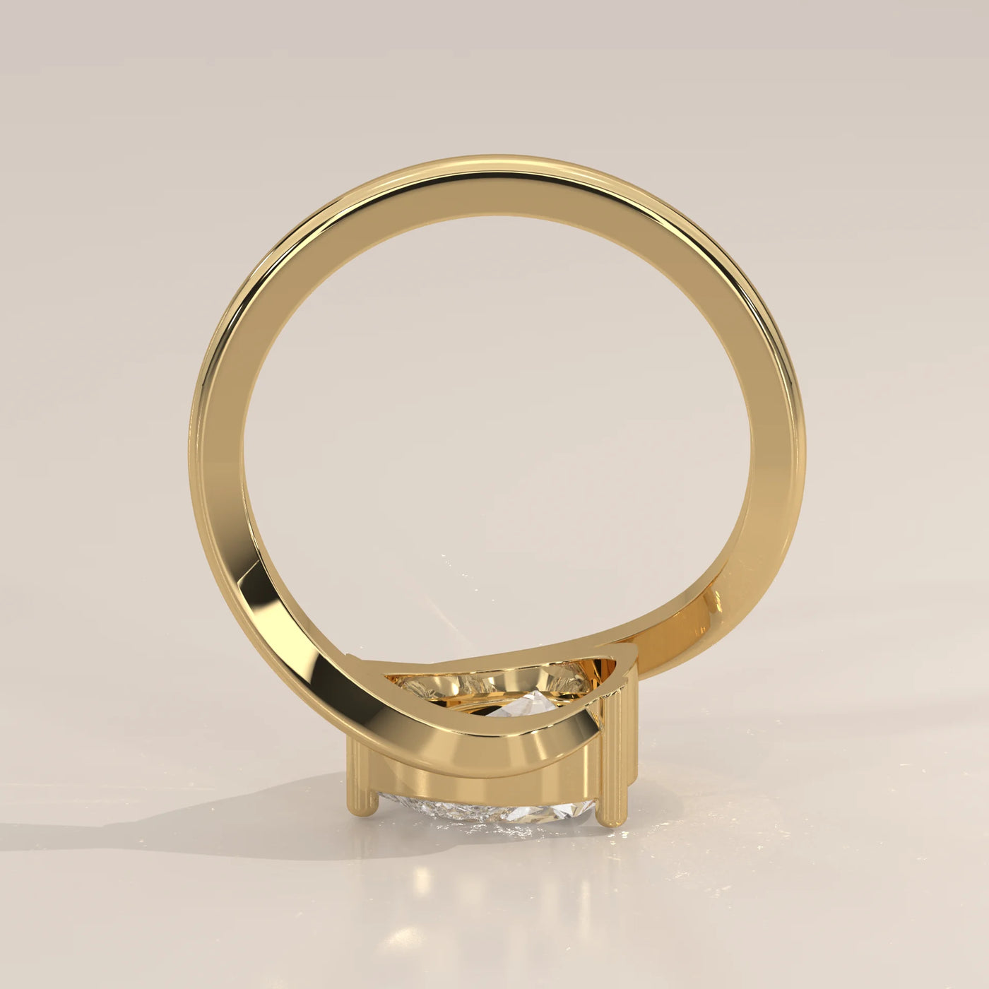 A delicate 14k gold ring with a pear-shaped diamond, shown from the side.