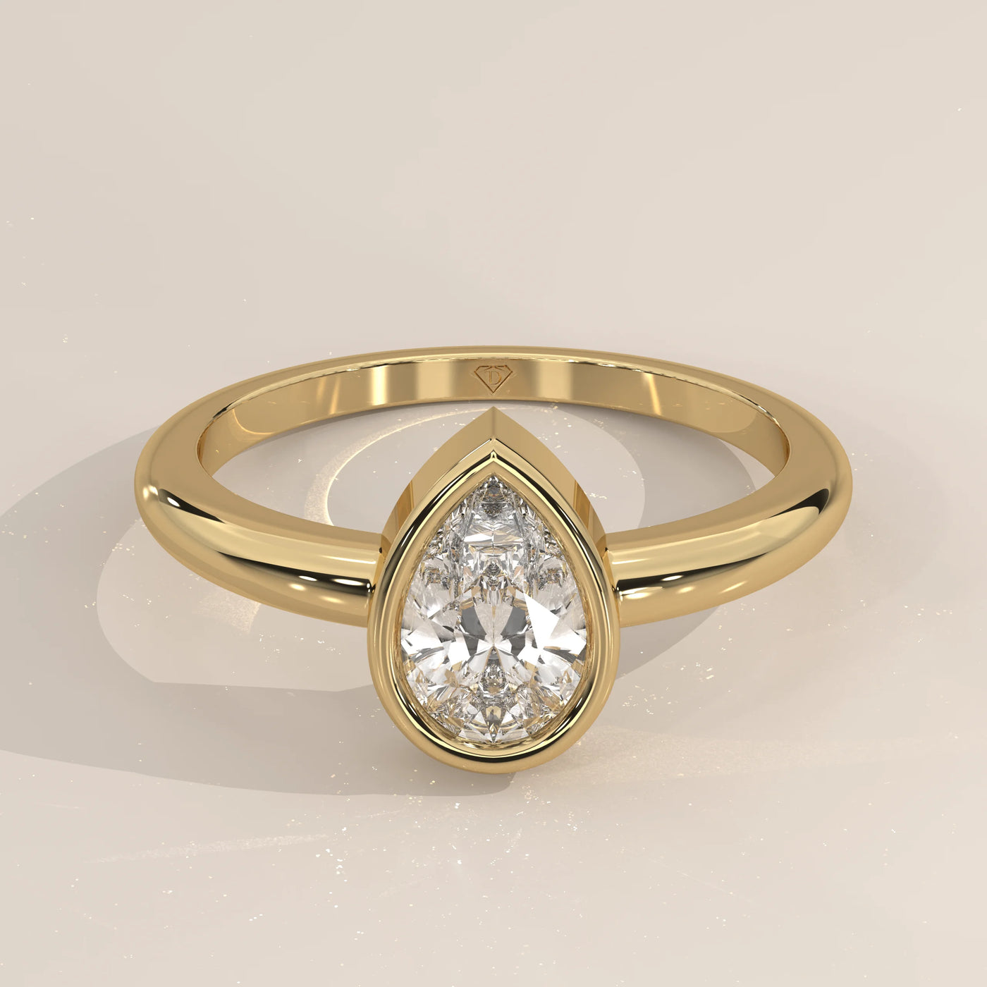 A stunning 18k gold ring featuring a prominent pear-shaped diamond.
