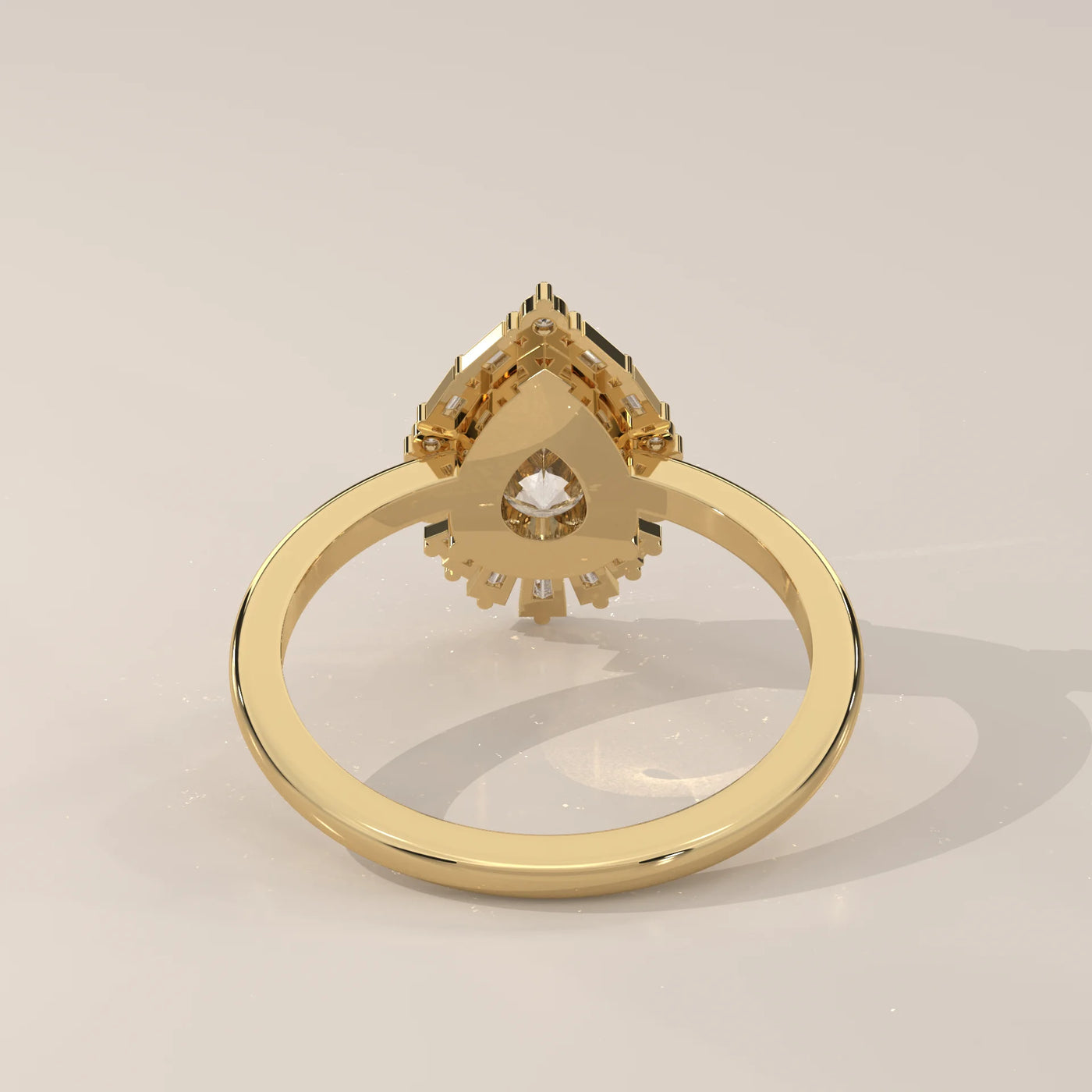 A 14k yellow gold ring with a pear-shaped diamond.