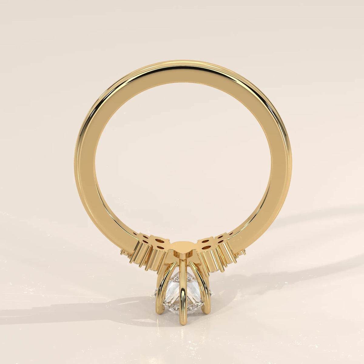 Yellow gold ring with a pear-shaped diamond and decorative band.