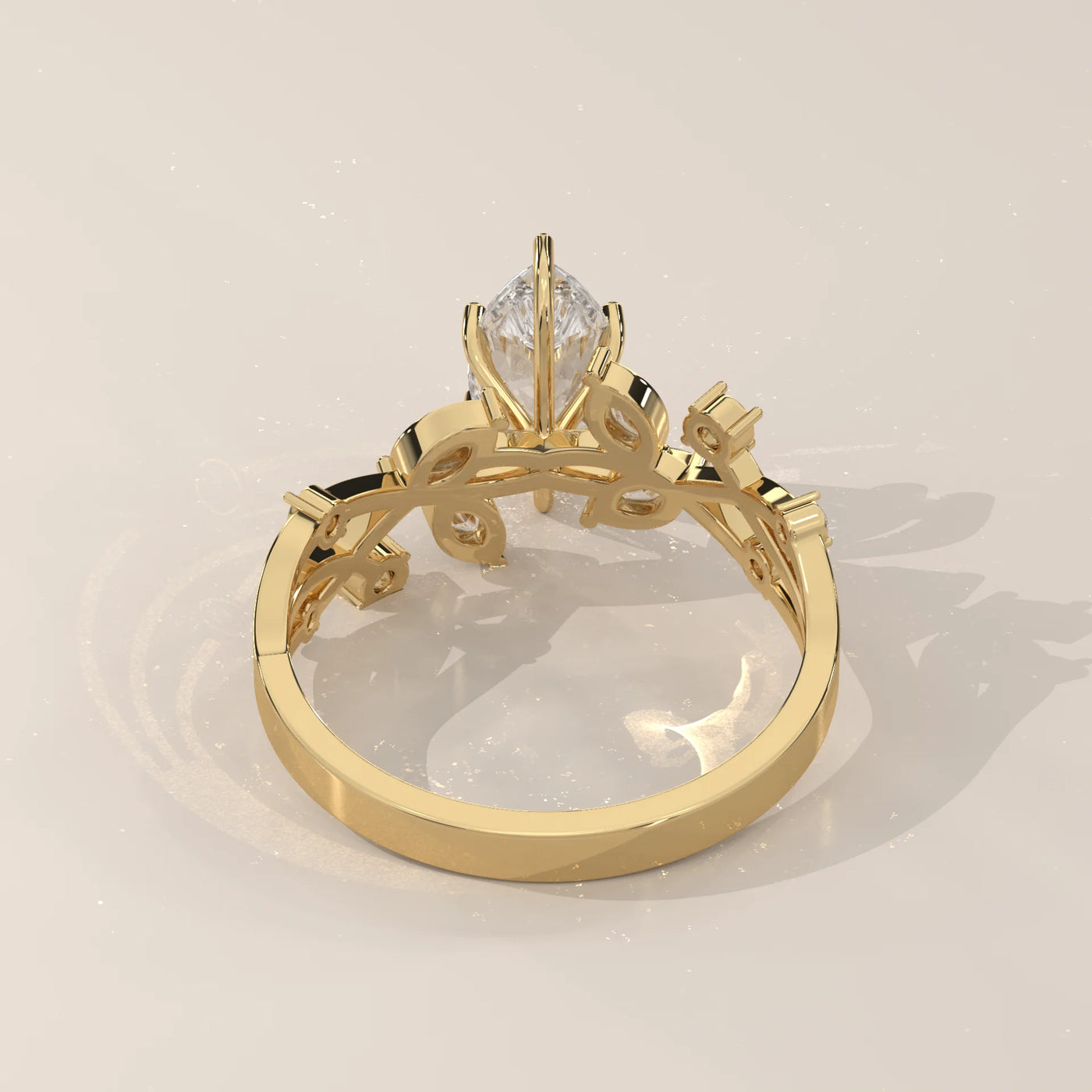Yellow gold ring with a pear-shaped diamond and decorative band.
