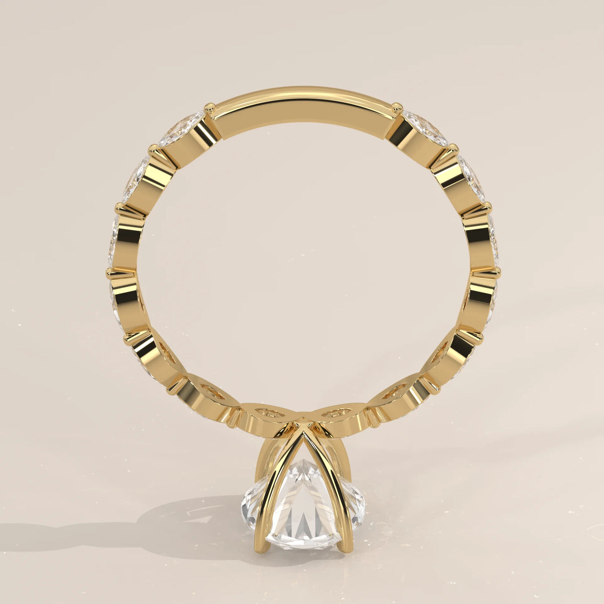 Yellow gold ring with a pear-shaped diamond and decorative band.