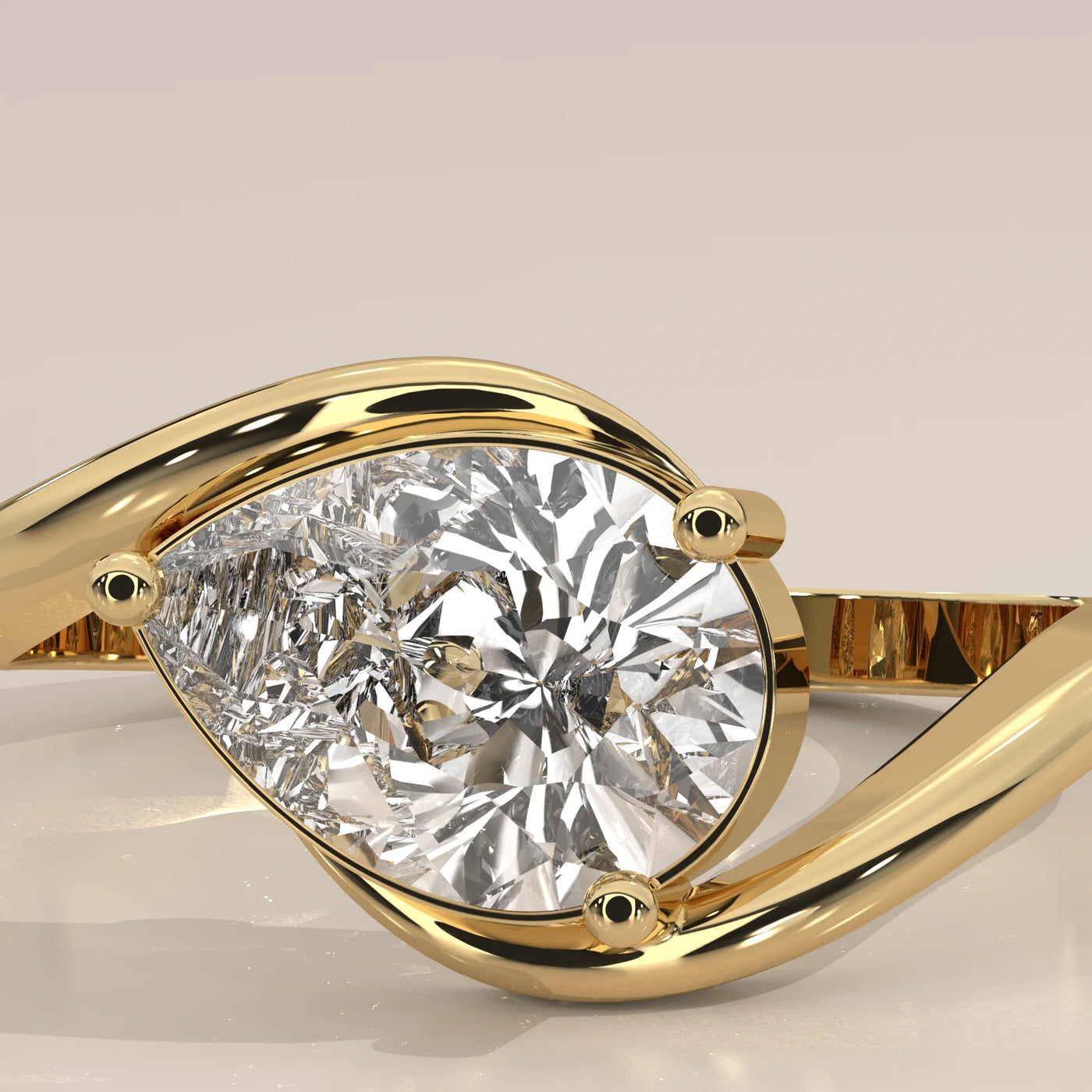 A close-up of a pear-shaped diamond ring in yellow gold.