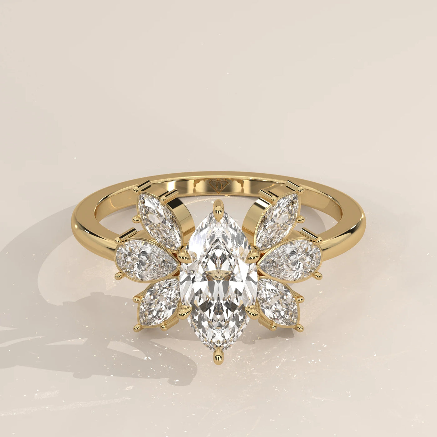 Yellow gold ring with a pear-shaped diamond centerpiece and surrounding marquise diamonds.