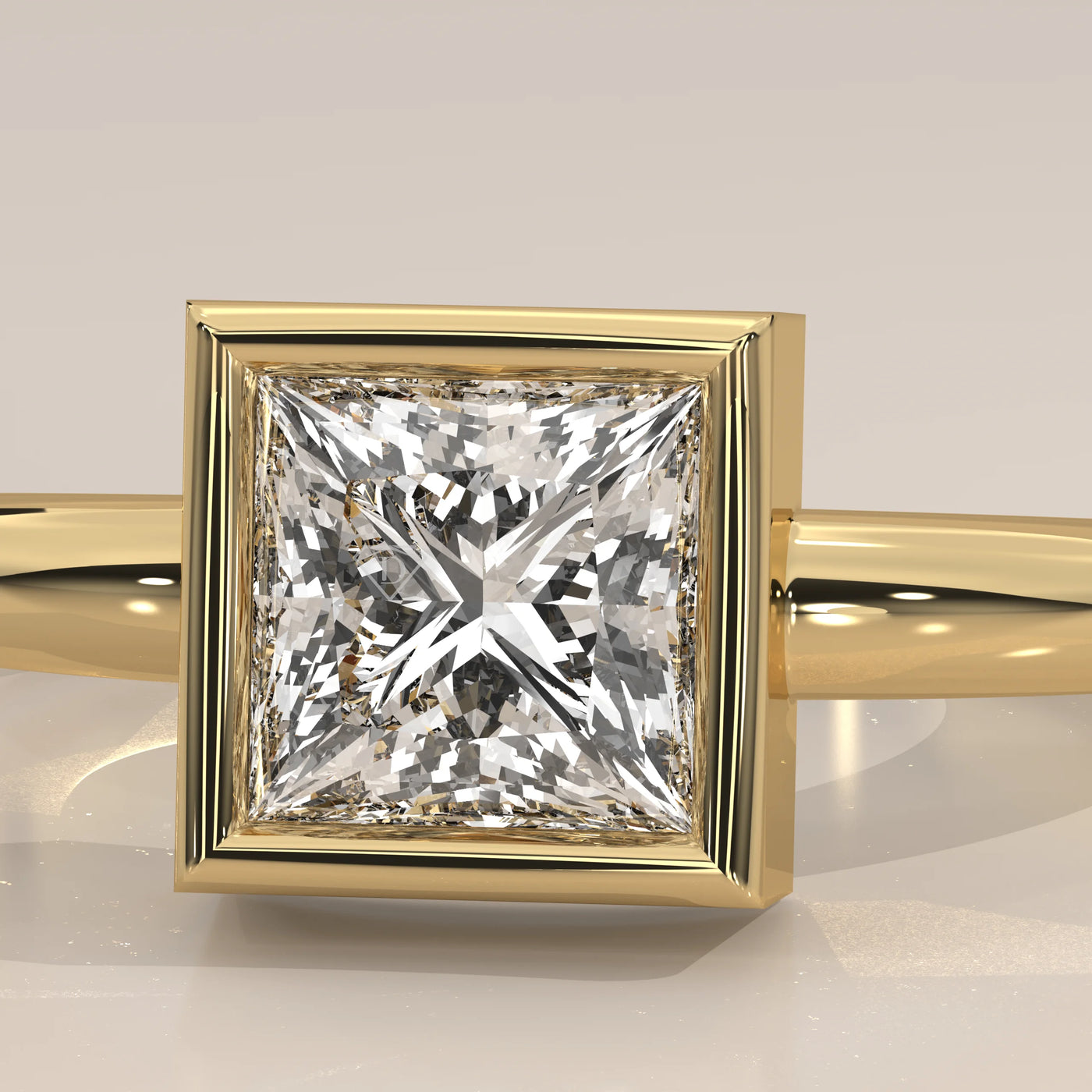 A princess cut diamond ring in a bezel setting with a yellow gold band.