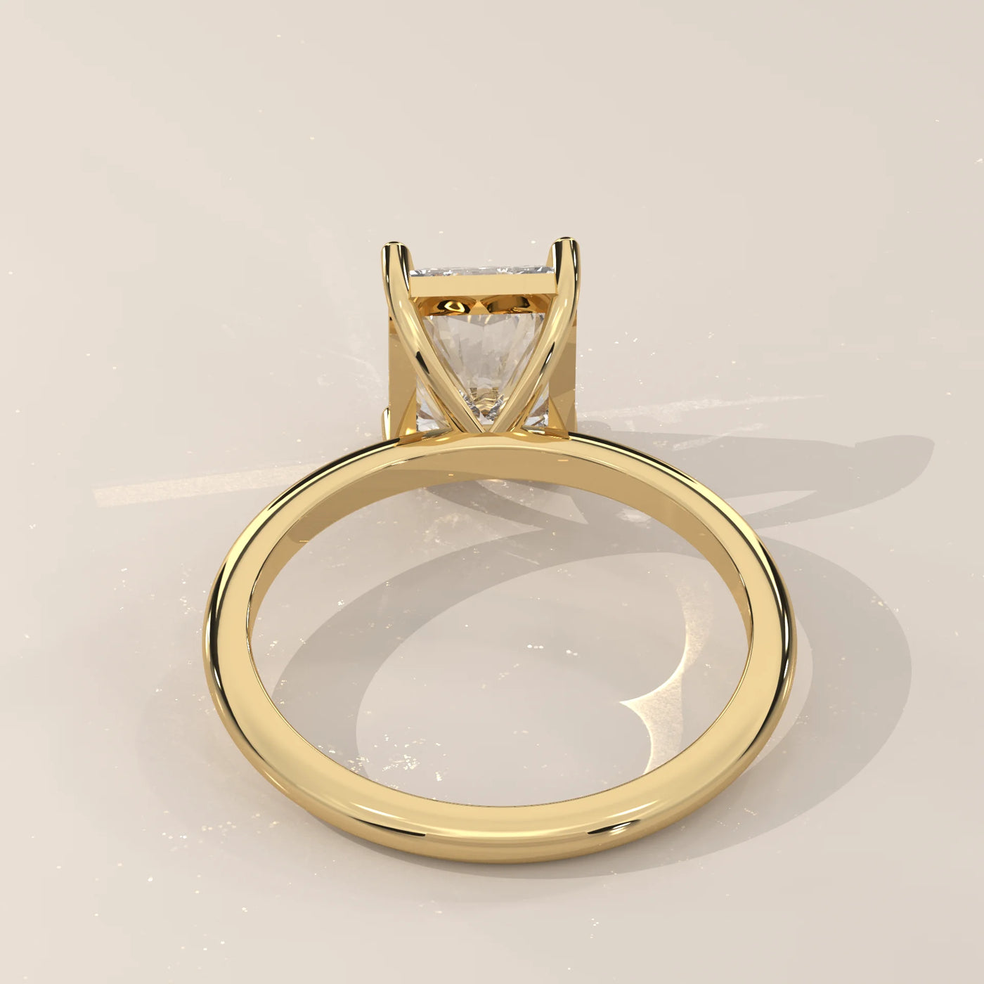A princess-cut diamond engagement ring set in 14k yellow gold with pave detailing.