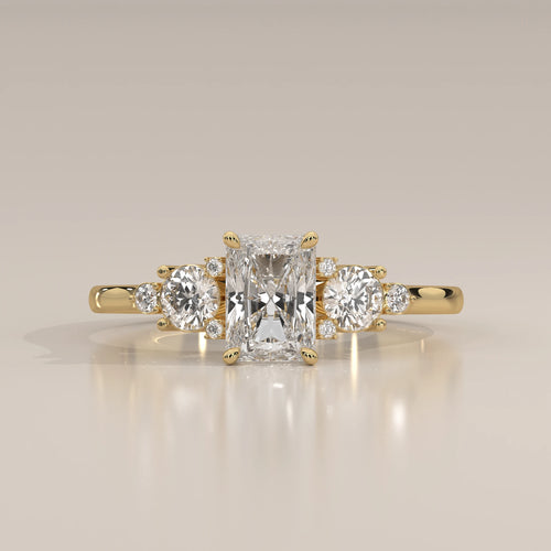 A radiant cut diamond engagement ring in 14k yellow gold.