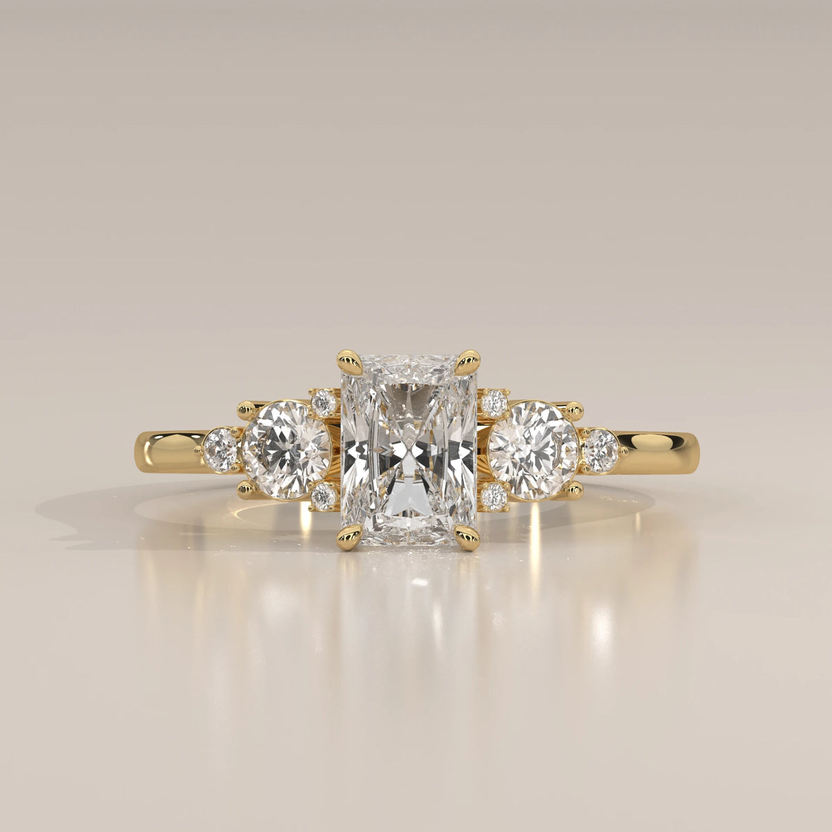 A radiant cut diamond engagement ring in 14k yellow gold.