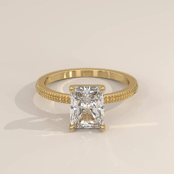 A radiant cut diamond engagement ring in 14k yellow gold.